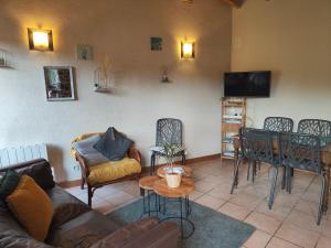 a living room with a couch and chairs and a table at Gite De La Tannerie 2 in Dinan