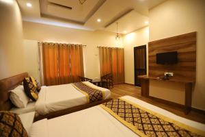 a hotel room with a bed and a television at The Park View Hotel in Amritsar