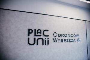 une clôture d’un panneau portant le logo de l’université brune dans l'établissement Plac Unii Apartments, à Gdynia