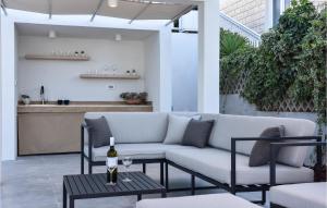 eine Terrasse mit einem Sofa und einem Tisch mit einem Glas Wein in der Unterkunft 5 Bedroom Cozy Home In Podstrana in Podstrana