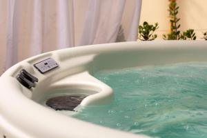 a toilet in a bath tub with water in it at Hotel Nautilus in Cagliari