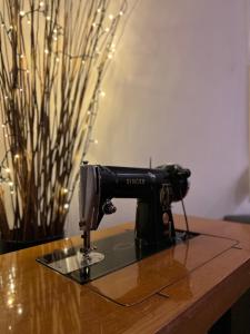 a sewing machine sitting on top of a wooden table at Nana's house in Chalkida