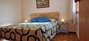 a bedroom with a bed with a colorful comforter at Riumar "Camins", 380m to beach, private pool, On-Site-Service, dog beach in Riumar +25 photos