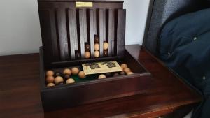 a wooden bin full of balls on a table at Stylish Town Centre Apartments in Nailsworth