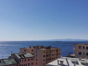 a view of the ocean from the roofs of buildings at Blue Nest in Genoa