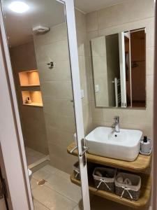 a bathroom with a sink and a mirror at Nana's house in Chalkida +26 photos