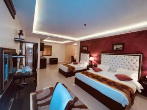 a hotel room with a large bed and a television at P Quattro Relax Hotel in Wadi Musa
