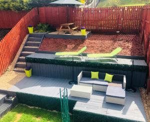 an aerial view of a patio with chairs and a table at Inverness Holiday House - 2 Bedroom in Inverness