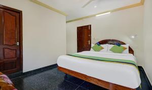 ein Schlafzimmer mit einem großen weißen Bett in einem Zimmer in der Unterkunft Itsy By Treebo - The Waters Edge Beach Resort in Kovalam