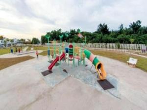 a playground with a slide in a park at 7eVenKitchen Hmestay in Jitra