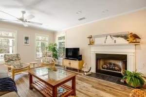 a living room with a fireplace and a tv at Anchors Away in Folly Beach