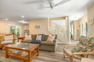 a living room with a couch and chairs and a table at Anchors Away in Folly Beach