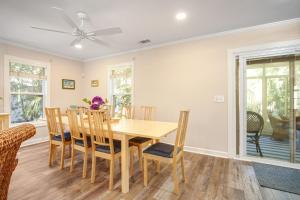 a dining room with a wooden table and chairs at Anchors Away in Folly Beach