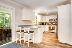 a kitchen with white cabinets and a blue counter top at Anchors Away in Folly Beach +30 photos