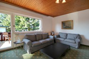 a living room with two couches and a table at Ferienhaus David Nikola in Binz