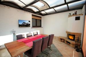 a dining room with a table and a fireplace at Ferienhaus David Nikola in Binz