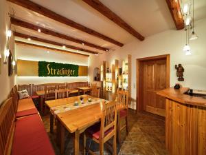 StratzingにあるAsbacher Klosterkellerの木製テーブルと椅子付きのレストラン