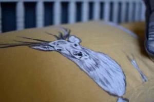 a drawing of a blue bird on a pillow at Inverness Holiday Retreat - 2 Bedroom in Inverness