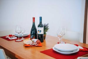 a table with two bottles of wine and glasses at Camping Wien in Peschiera del Garda