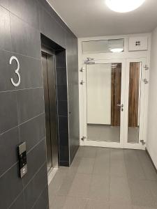 a bathroom with a number eight on the wall at Apartament Near Sky Tower Free Parking for 2 cars in Wrocław