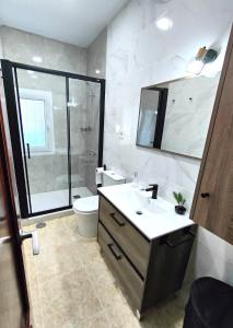 a bathroom with a sink and a toilet and a shower at Wallada Marbella in Marbella