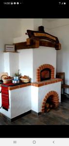 een bakstenen oven in een keuken met wat brood bij Ograda Bunicilor in Baia de Fier