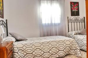 A bed or beds in a room at Apartamento Cortes