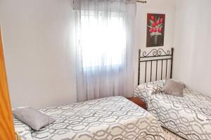 A bed or beds in a room at Apartamento Cortes