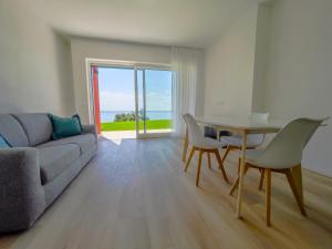 a living room with a couch and a table and chairs at Villa Beole in Bardolino