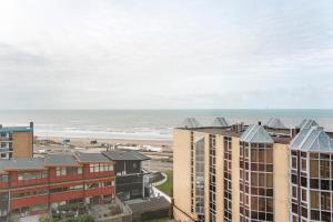 a view of the beach from the balcony of a building at Private Suite with stunning sea view in Zandvoort