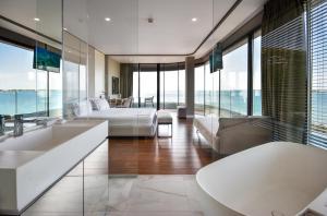 a hotel room with a bed and a couch at Yacht Hotel in Vlorë
