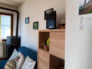 a living room with a tv on top of a dresser at One bedroom appartement with balcony and wifi at Monterosso Grana in Levata
