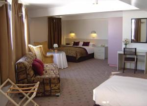 A bed or beds in a room at Perisher Manor Hotel