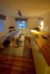 a kitchen with a table and a dining room at Ferienhaus im Fichtelgebirge in Nagel