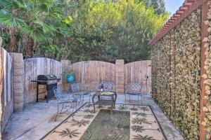 a patio with chairs and a grill and a fence at Bright Poway Studio with Shared Outdoor Oasis! in Poway