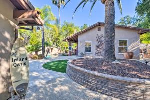 a house with a surfboard in front of a house at Bright Poway Studio with Shared Outdoor Oasis! in Poway