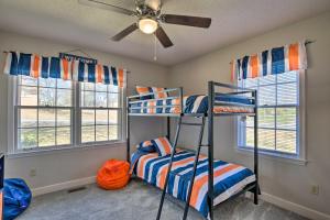 a bedroom with two bunk beds and two windows at Pet-Friendly Easley Family House with Game Room in Easley