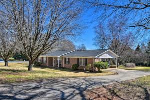 a brick house with a tree and a driveway at Pet-Friendly Easley Family House with Game Room in Easley