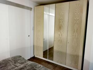 a bedroom with a closet with a mirror at Ferienwohnung Pufitsch in Gmünd in Kärnten