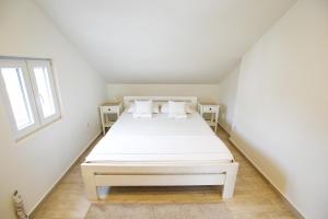 Postel nebo postele na pokoji v ubytování Apartmani Vidakovic
