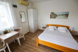 Postel nebo postele na pokoji v ubytování Apartmani Vidakovic
