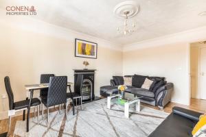 a living room with a couch and a fireplace at Stunning 2-Bed Apartment in Grays in West Thurrock