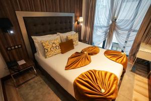 um quarto com uma cama com lençóis laranja e uma janela em SBN Suite Hôtel em Tânger
