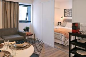 a room with a bed and a table and a chair at JP Crauford Hospedagem in Sao Paulo +21 photos
