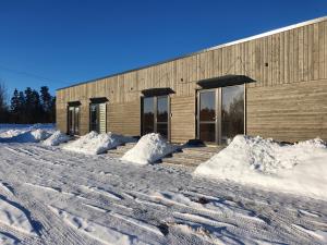 a building covered in snow in front at Sila terases in Madona