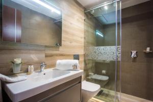 a bathroom with a sink and a shower and a toilet at SBN Suite Hôtel in Tangier