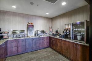 a bar with wooden cabinets and a counter top at Inn at Hunters Run in Watford City