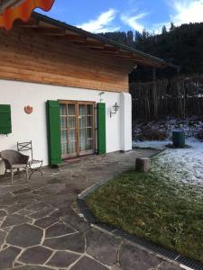 a house with a green door and a patio at Gundhabing flat in Kitzbühel