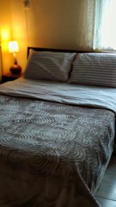 A bed or beds in a room at Alexandros Guesthouse