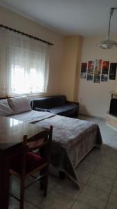 A bed or beds in a room at Alexandros Guesthouse